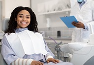 Woman smiling while sitting in treatment chair