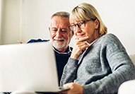 Patient in Carmel looking at denture financing options online