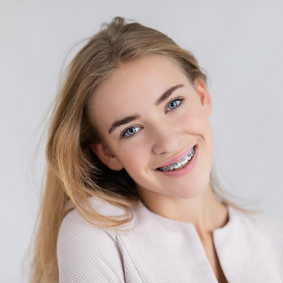 A beautiful blonde girl wearing traditional braces