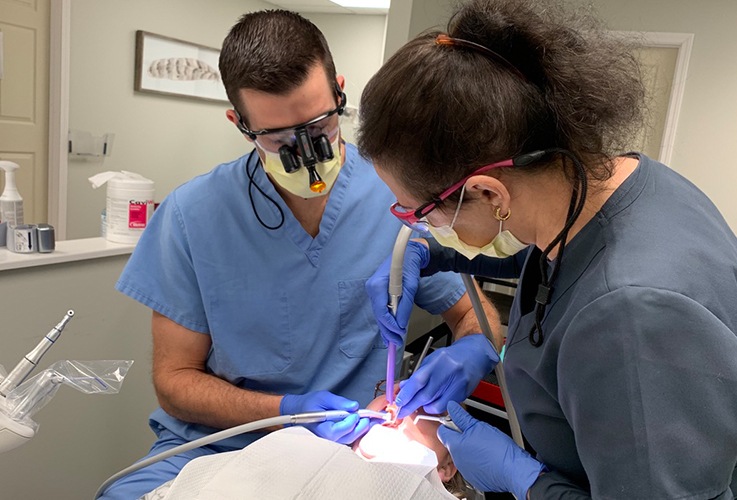 Dr. Springhetti and team member treating dental patient