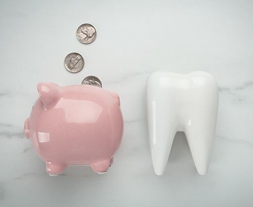 piggy bank and tooth for cost of cosmetic dentistry in Carmel 