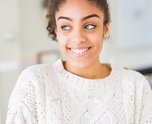 a woman smiling after visiting a cosmetic dentist in Carmel