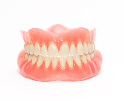 Full set of dentures with a white background