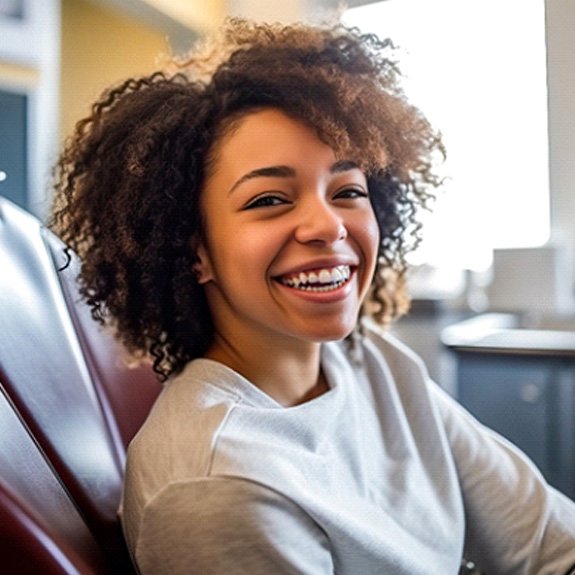 Woman in dentist’s chair smiling