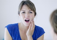 Woman with toothache holding cheek