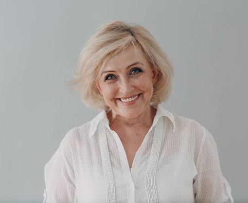 Lady smiles with dentures in mouth