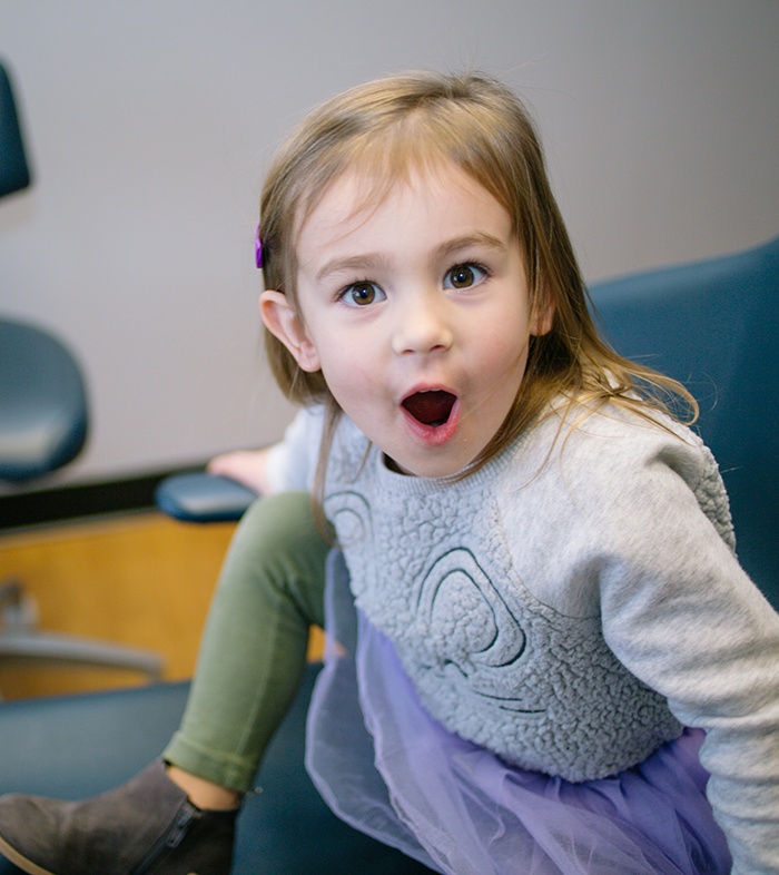 Little girl in dental chair looking surprised