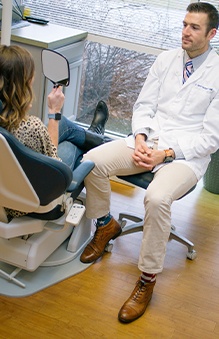 Dentist talking to patient in the dental chair