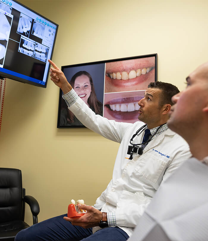 Doctor Springhetti showing a patient x rays of their teeth