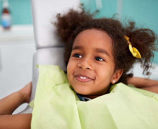 Smiling young girl in dental chair