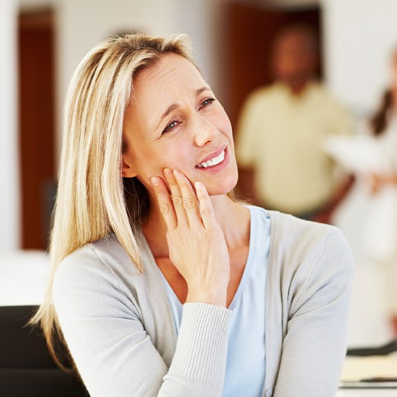 Woman in pain holding jaw