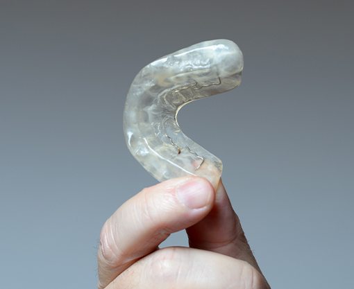 Hand holding an occlusal splint