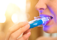 patient in Carmel using at-home teeth whitening