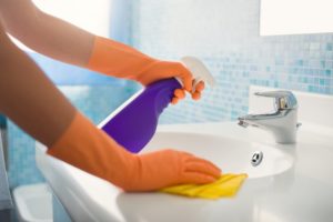 person cleaning their bathroom