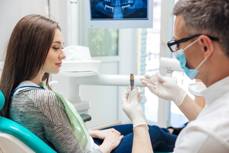 Dentist explaining dental implants to patient 