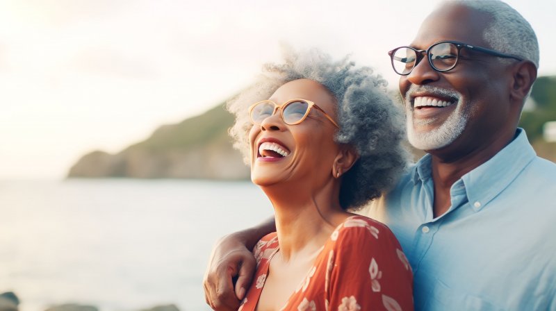 Older couple smiles by lake